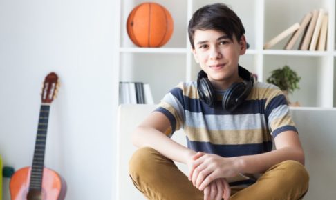 ソファに座って微笑んでいる外国人中学生