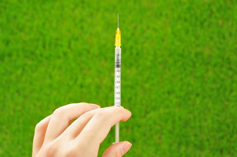 注射器を持つ女性の手