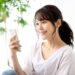 春の日差しの中でスマホを操作している女性